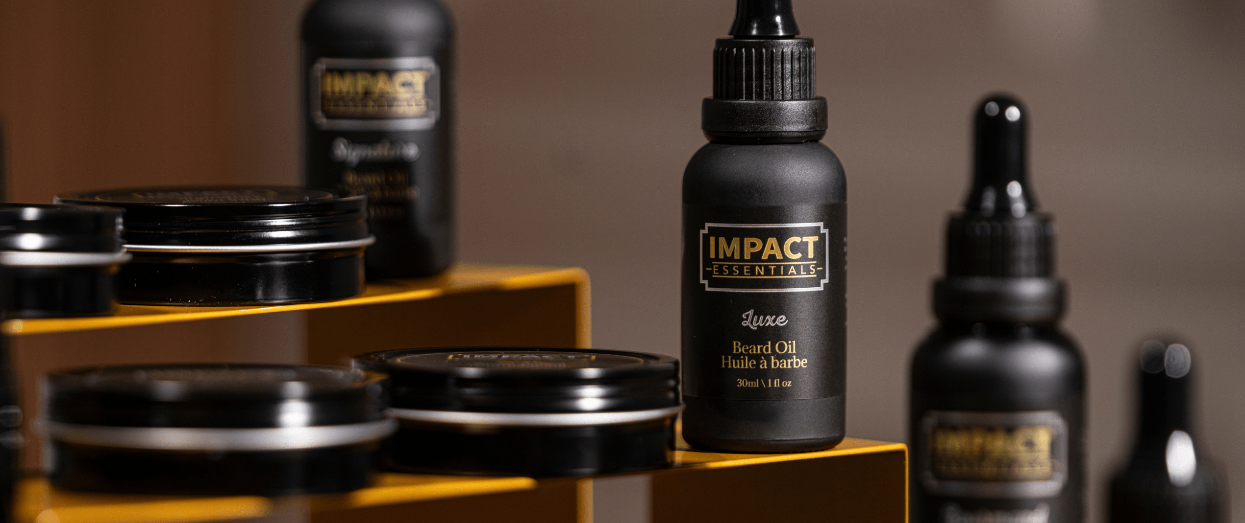 A man using IMPACT Essentials premium beard oil and grooming tools as part of his daily ritual.