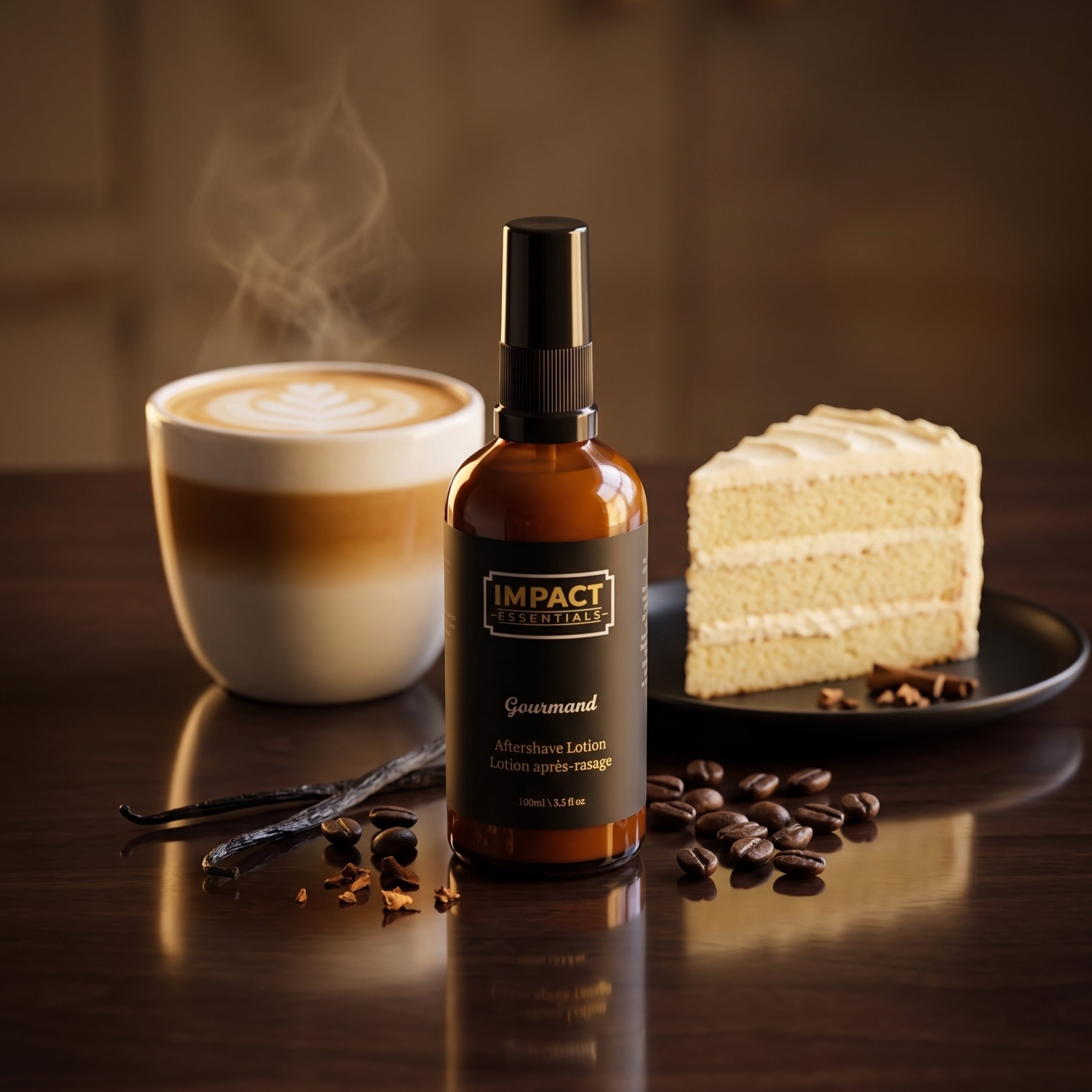 A bottle of Impact Essentials AftershaveAbsorbing Lotion stands on a dark wooden table, styled with a cup of latte with steam, a slice of layered cake, coffee beans, and vanilla beans.
