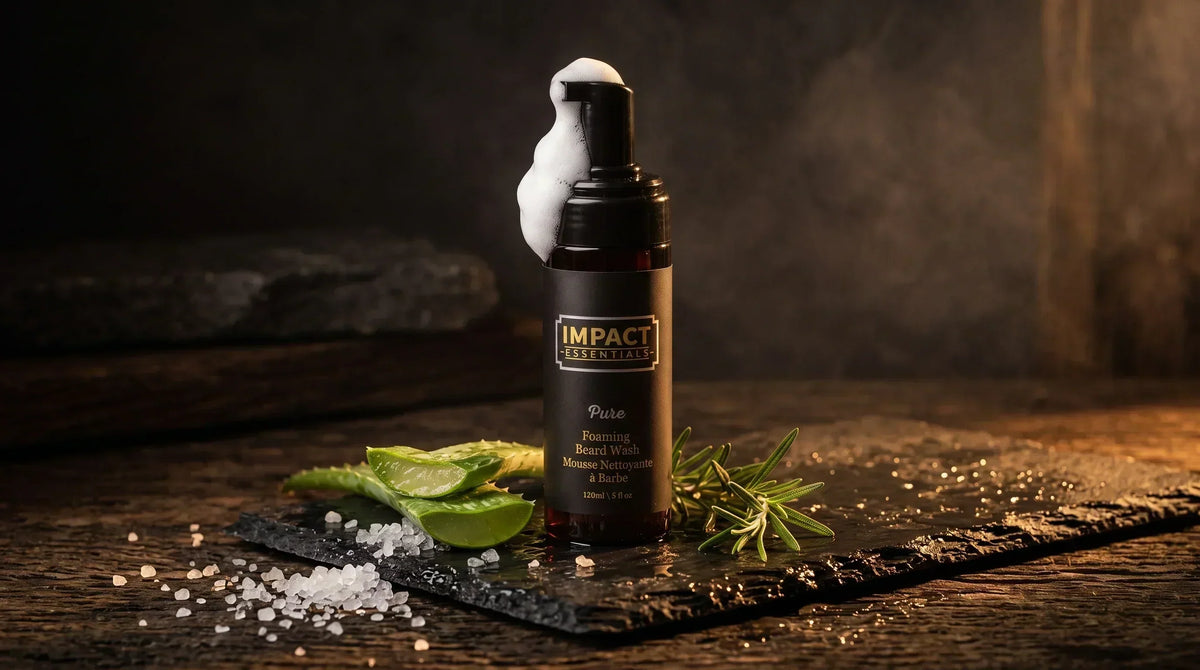 Sulfate free beard wash - Matte black dispenser pump foaming rich lather on dark slate with raw sea salt crystals.