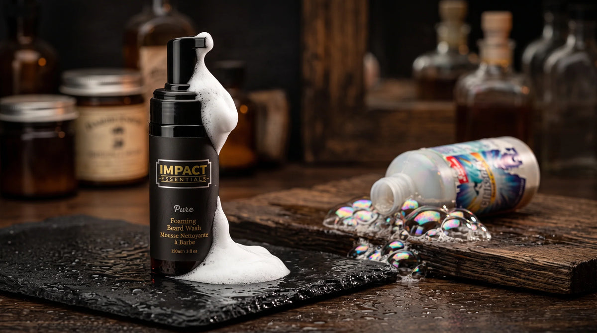 Natural foaming beard wash bottle on wet black slate with rich foam cascading down, contrasted with an overturned generic cleanser spilling iridescent bubbles on rustic wood.