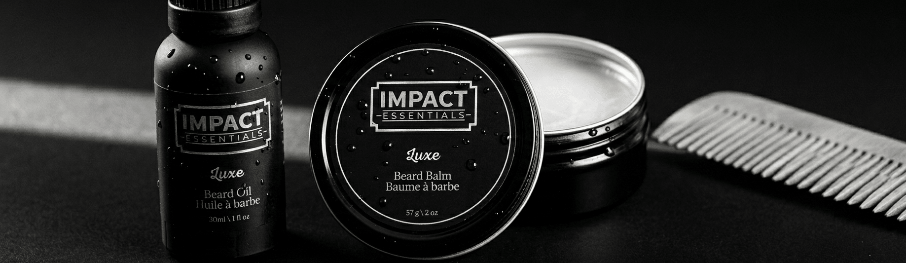 Close-up of IMPACT Essentials grooming products featuring signature black, gold, and silver branding.