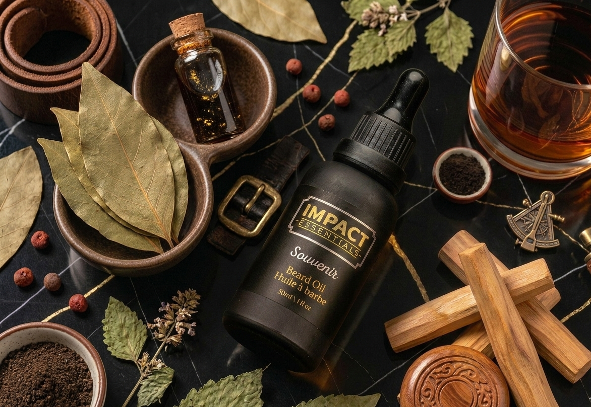 Impact Essentials Savour Beard Oil bottle surrounded by leaves, spices, and a glass of liquid on a dark surface.